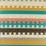 closer look at cushion with Teal and Mustard Aztec pattern.