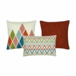 One diamond design cushion,one plain red cushion and one rectangular zigzag design cushion.
