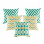 Five cushion in gold and teal colours with diamond and chevron designs.