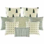 two cushion cover with black and white stripes, two black and white with small cross design, one plain white fur, two pine tree printed cushion, and one rectangular cushion cover