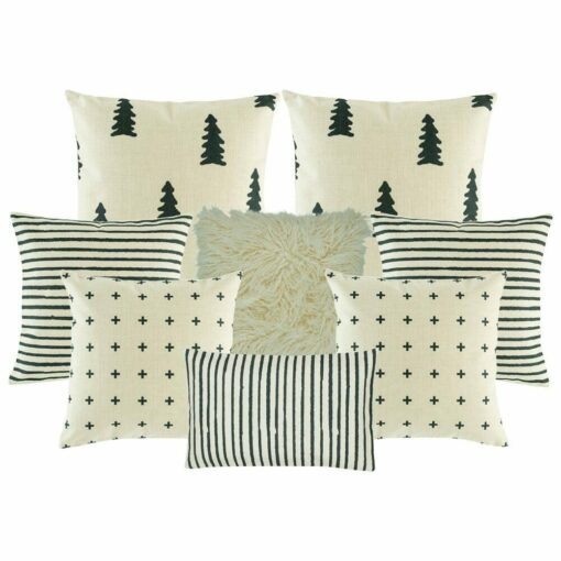 two cushion cover with black and white stripes, two black and white with small cross design, one plain white fur, two pine tree printed cushion, and one rectangular cushion cover