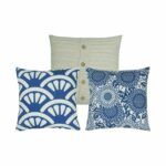 One cable knit with buttons cushion cover and two patterned cushion covers in blue and white colours.