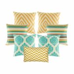 Four multi patterned cushion in gold and teal colours with diamond, zigzag and crown designs.