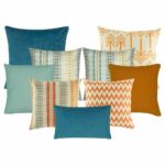 Four multi patterned cushion, one arrow design cushion and chevron cushion with orange colour. Two patterned cushion in teal, grey and orange colours. one set of plain cushion in teal and orange, one plain rectangular cushion in Blue colour.
