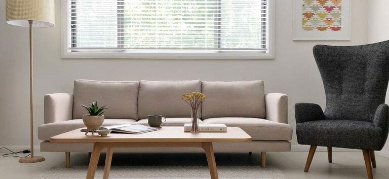 A simple neutral sofa and highback chair.