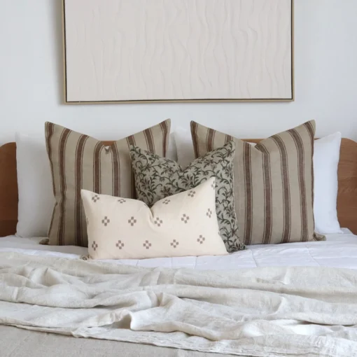 Four designer Amaro bed cushions add a pleasing look to the wooden bed.