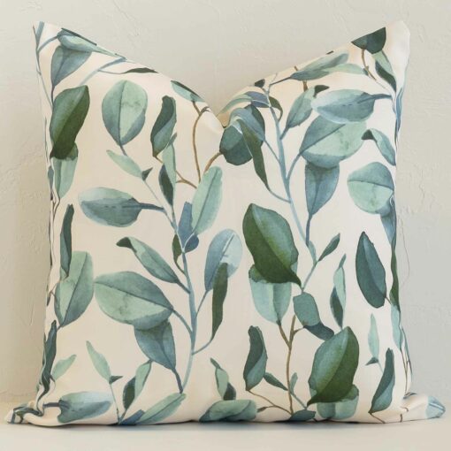 Avena Waterproof Eucalyptus Outdoor Cushion Cover - SC1053-45 A brick wall that has a floral white cushion cover positioned in front of it. It has an exquisite outdoor material and a lovely square shape.