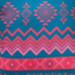 Close up image of geometric outdoor cushion cover with diamonds and zigzag pattern