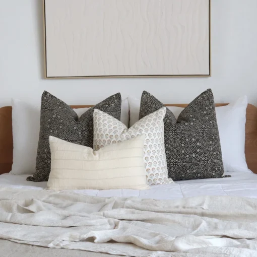 A white bedroom looks classy with the 4 Essa designer bed cushions perfectly placed on a bed.
