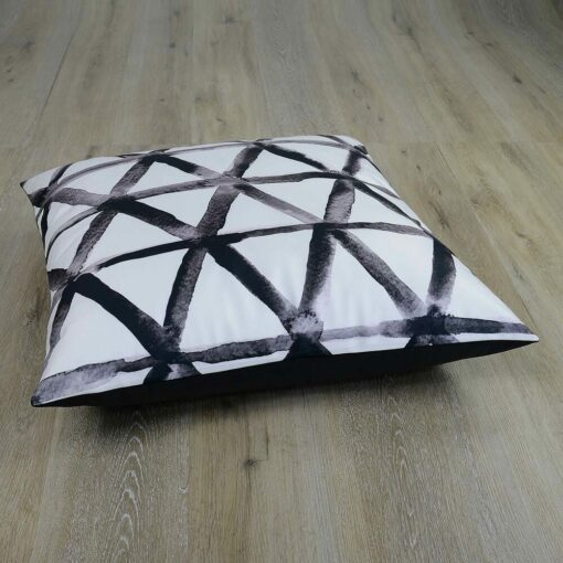 Photo of white floor cushion with black triangles