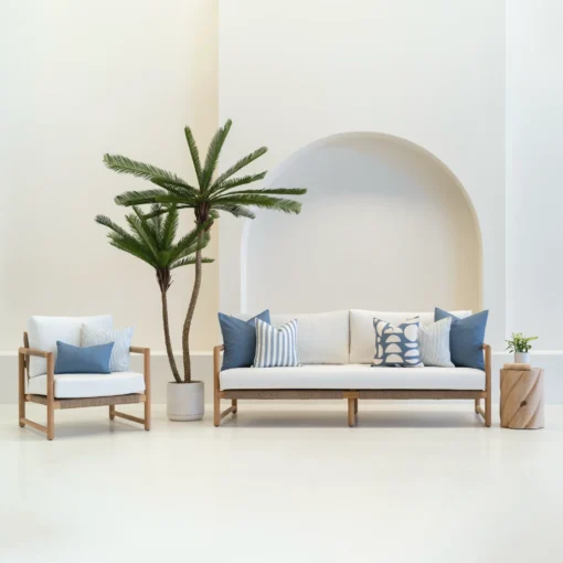 Living room scene with 7 horizon blue outdoor sofa cushions arranged on a white sofa.