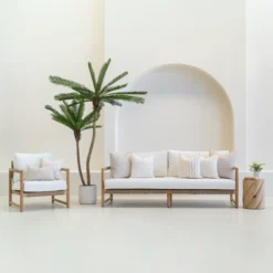 A set of 7 horizon sand outdoor sofa cushions sitting on a white sofa.