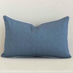 A solid-coloured outdoor cushion in a sleek rectangle size with a blue tone of colour.