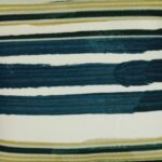 Close up image of teal and olive green outdoor cushion made of UV resistant fabric
