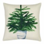 Photo of plain cotton linen cushion with potted green plant