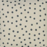 Photo of plain cotton linen bedroom cushion with grey polka dots