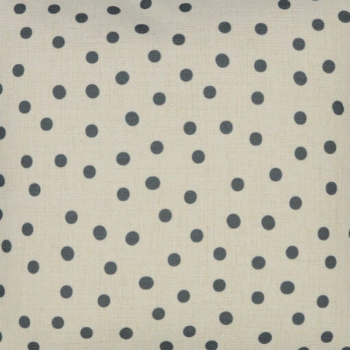 Photo of plain cotton linen bedroom cushion with grey polka dots