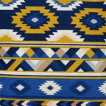 Close up image of Mexican tribal inspired cushion cover with white, blue and yellow colours