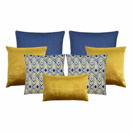 A collection of seven cushion covers featuring two blue cushions, three gold cushions and two chevron design cushions.