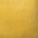 Close up image of mustard yellow cushion cover made of cotton fabric