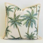 Square Palmera outdoor cushion with palm tree pattern and fringed edges.