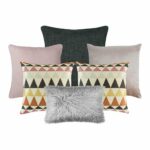 A collection of six cushion covers featuring one charcoal grey cushion, two pink cushions, two patterned cushions and one grey faux fur rectangular cushion cover.