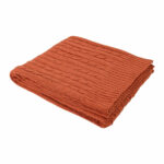 Alluring rust knitted throw blanket perfect for draping over a contemporary sofa