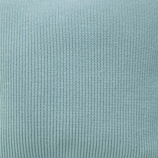 Close up photo of knitted cushion cover of teal colour