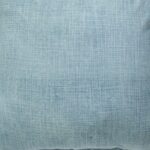 Close up image of denim blue cushion cover made of sand blasted cotton fabric