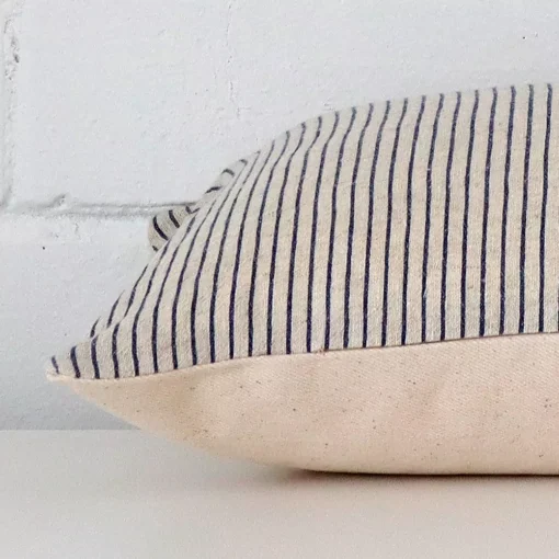 Lateral angle image of a designer rectangle cushion. The striped design is highlighted along its seams.