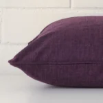 Side image of a linen square cushion cover. A close up of the purple colour.