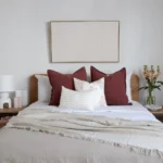 Above the Ali set of 4 bed cushions, a framed wall art decoration hangs elegantly.