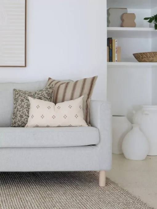 3 cushions Cushions from the set of 5 designer cushions for the Amaro set are arranged in the corner of an elegant grey sofa.