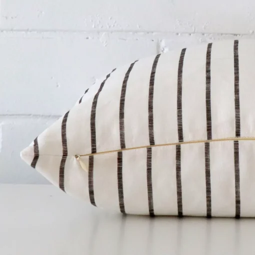 A rectangle cushion cover laying flat. This viewpoint highlights the striped style and linen fabric from a side position.