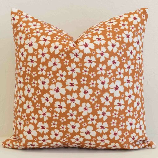 amora-ditsy-floral-cushion-cover---sc1106-45 Amora ditsy floral cushion with white flowers on warm orange background.