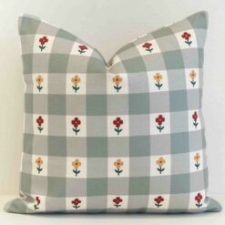 Amora gingham check cushion with small flowers on soft green grid pattern.