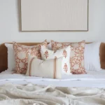 The Aria bed cushions set is neatly arranged on a wooden bed with white bedding.