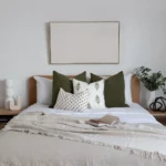 The olive-coloured bed cushions placed beside a green plant create a natural vibe.