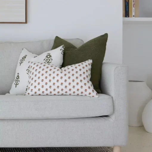 Two designer cushions from the Luka sofa cushion set of 5 adorn a corner of the grey sofa.