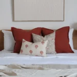 The set of 4 Avery bed cushions adds warmth to the bedroom with white-painted walls.
