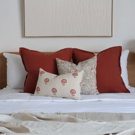 The set of 4 Avery bed cushions adds warmth to the bedroom with white-painted walls.
