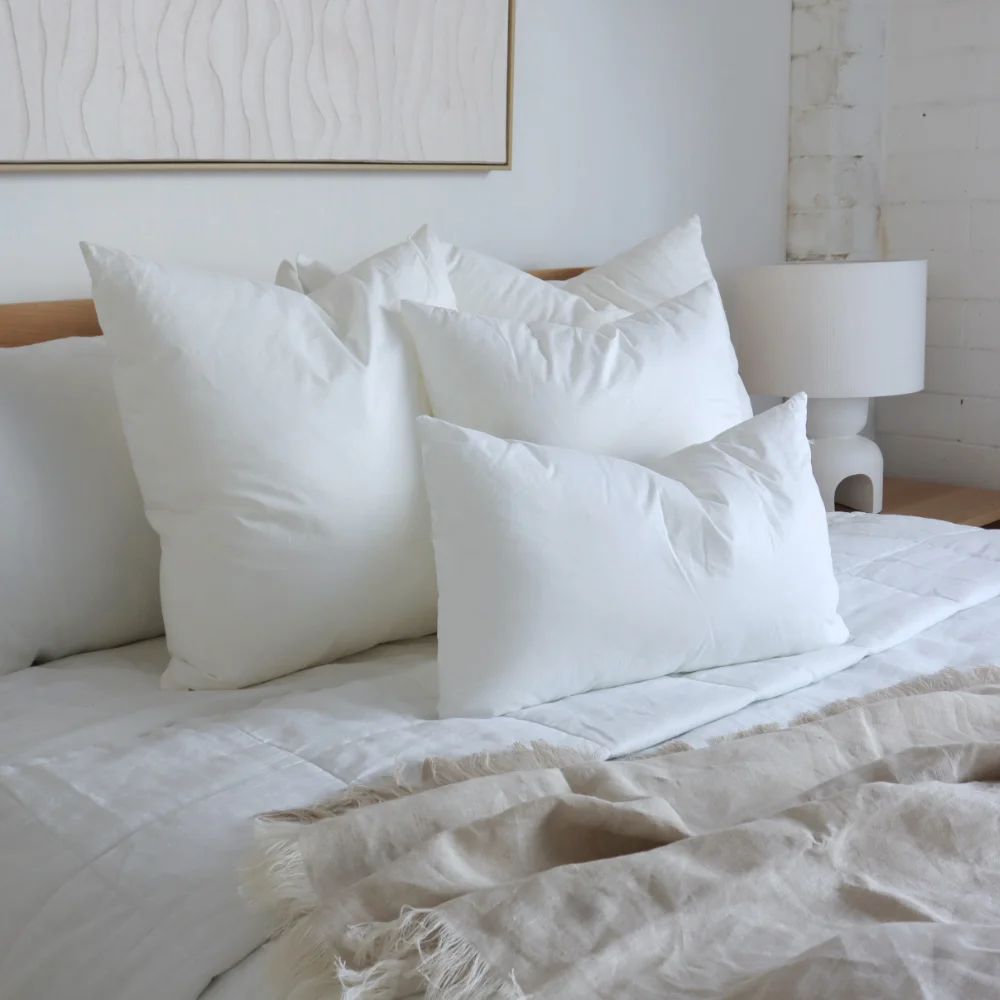 A bed is shown with different cushion inserts sitting on it.