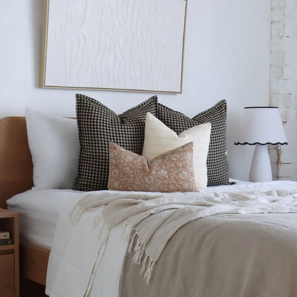 Bed cushions styled in a bedroom scene.