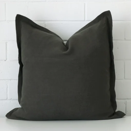 A graceful large moss green cushion that is made from a linen fabric.