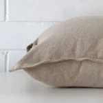 Horizontal edge view of front and back panels of linen cushion in a large size and with stone colouring.