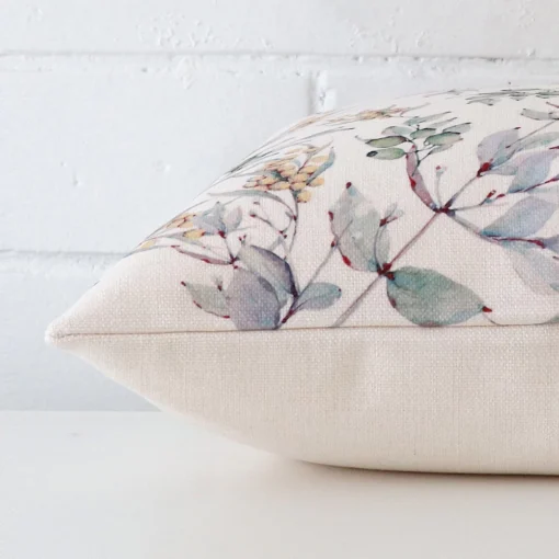 A square cushion cover laying flat. This viewpoint highlights the style and linen fabric from a side position.