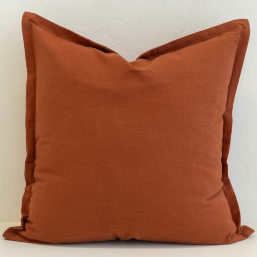 Burnt orange linen cushion with warm earthy tone and soft texture.