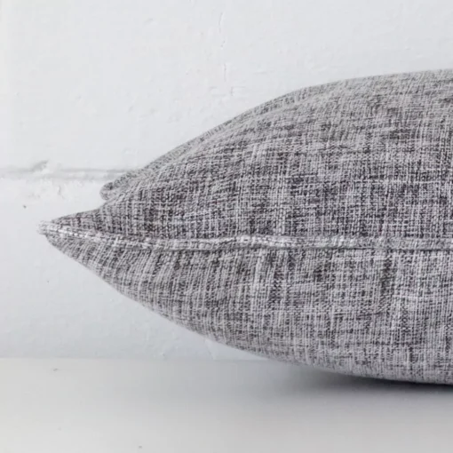 A rectangle linen cushion positioned flat to show its seams. The grey colour is visible as is the seam between the panels.
