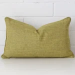 A rectangle cushion in a delightful olive tone rests against a white wall. The linen material appears to be of exceptional quality.