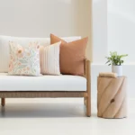 Outdoor cushions from the set of 3 avena are arranged neatly on a white couch.